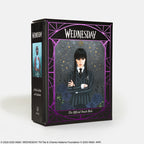 Card deck packaging for 'Wednesday' with character illustration and purple decorative elements on a white background.