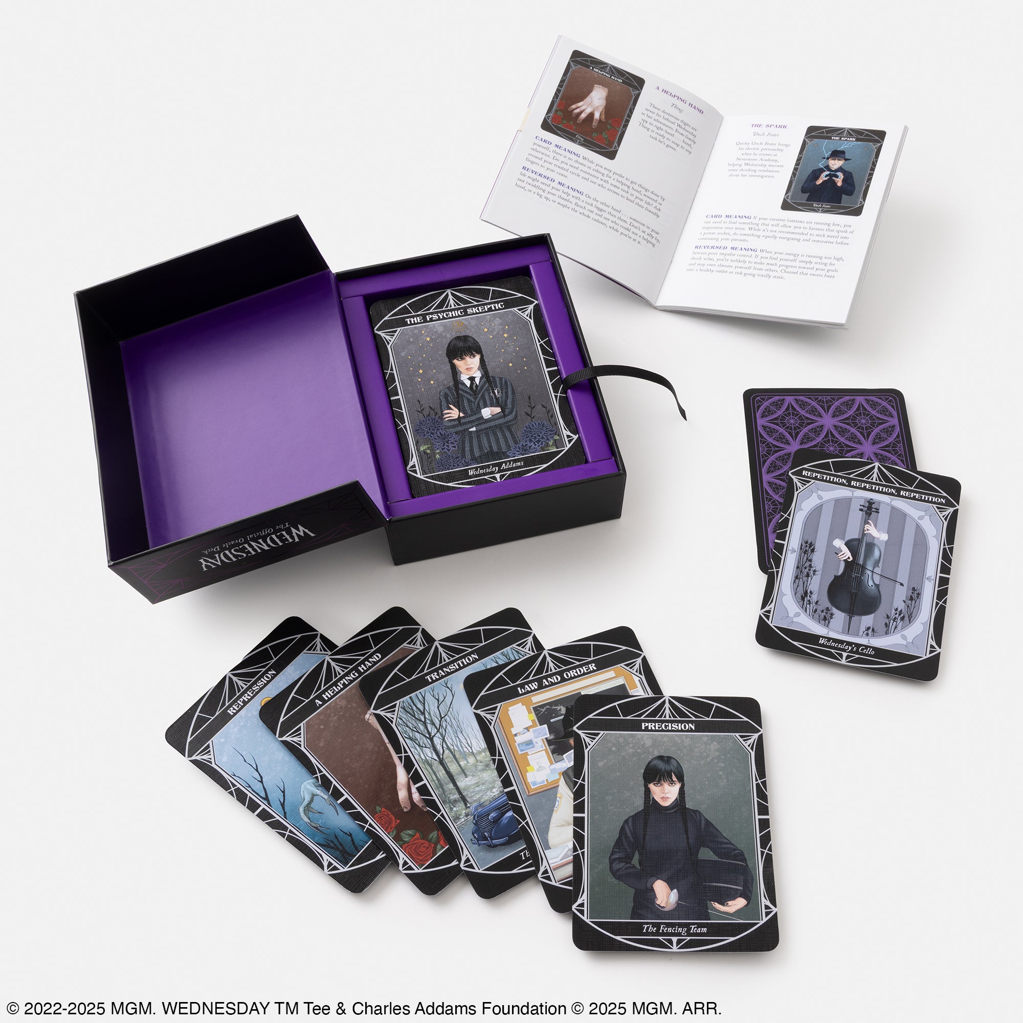 Set of tarot cards with a purple box and instruction manual on a white background