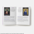 Open book showing tarot card illustrations with card meanings on a white background