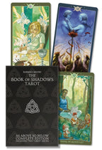 Tarot cards with colorful illustrations and a black book titled 'The Book of Shadows Tarot' on a white background.