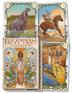 Three cards and the box cover from a deck titled 'Egyptian Lenormand' with various illustrations including a hippo, a person on a horse, a woman in a headdress, and a scene with people and animals.
