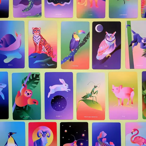 Colorful tarot cards with various animals and symbols on a green background