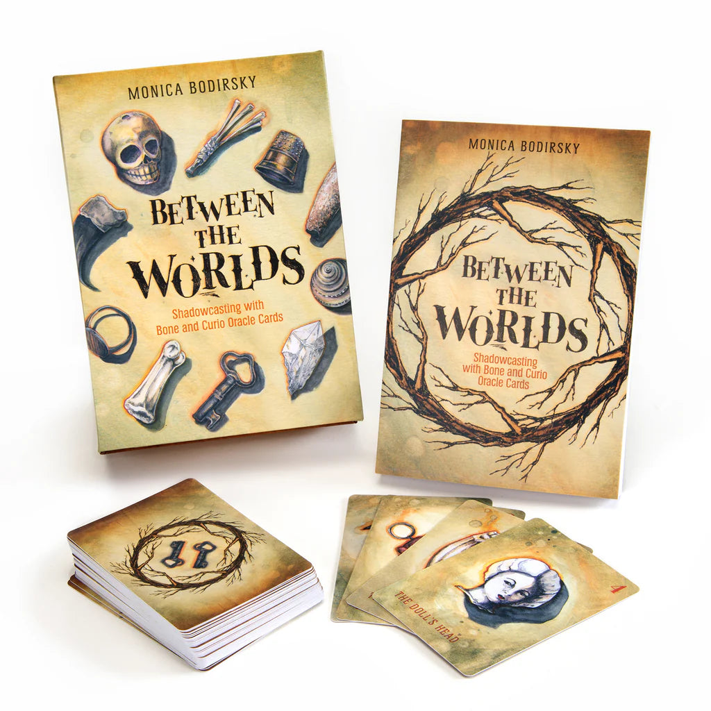 The Oracle and guide book for 'Between the Worlds' by Monica Bodirsky with cards on a white background