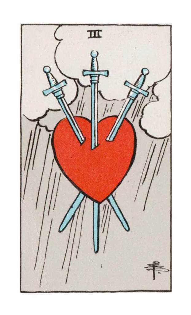 Tarot card with a red heart pierced by three blue swords, on a light gray background.