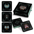 Insecta Obscura Tarot deck shown with a black illustrated box, two small teal tins, and four tarot cards featuring moths and butterflies on a white background.
