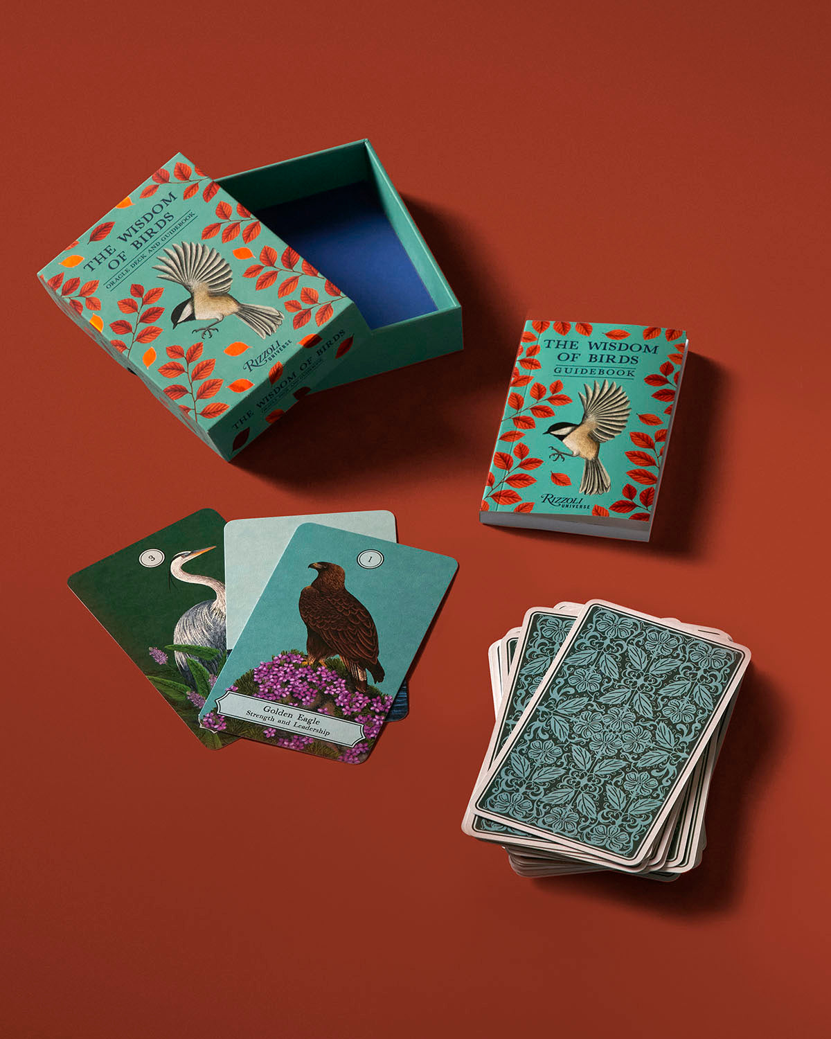 Card game set with bird-themed cards and a decorative box on a red background