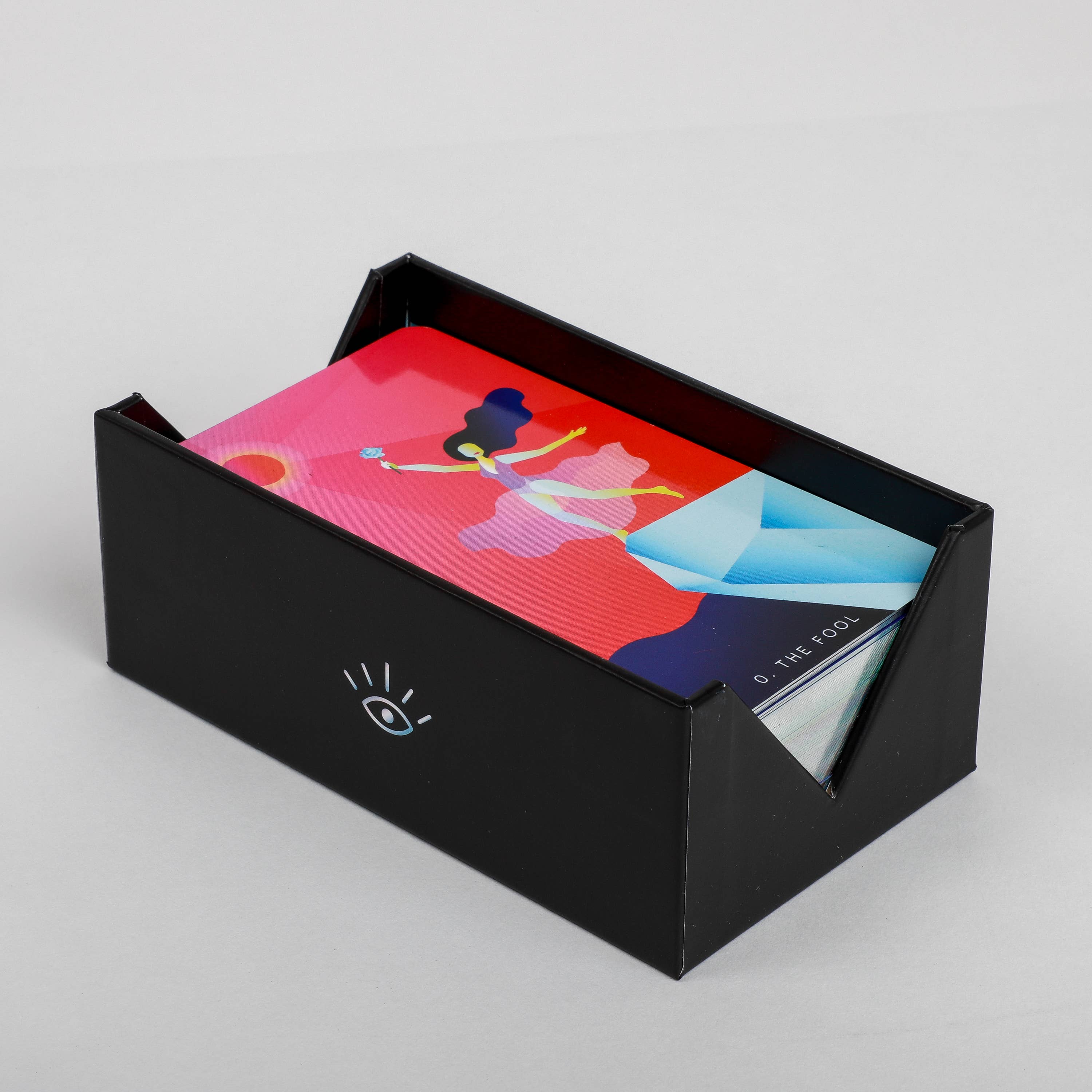 Black box with colorful cards inside on a light gray background
