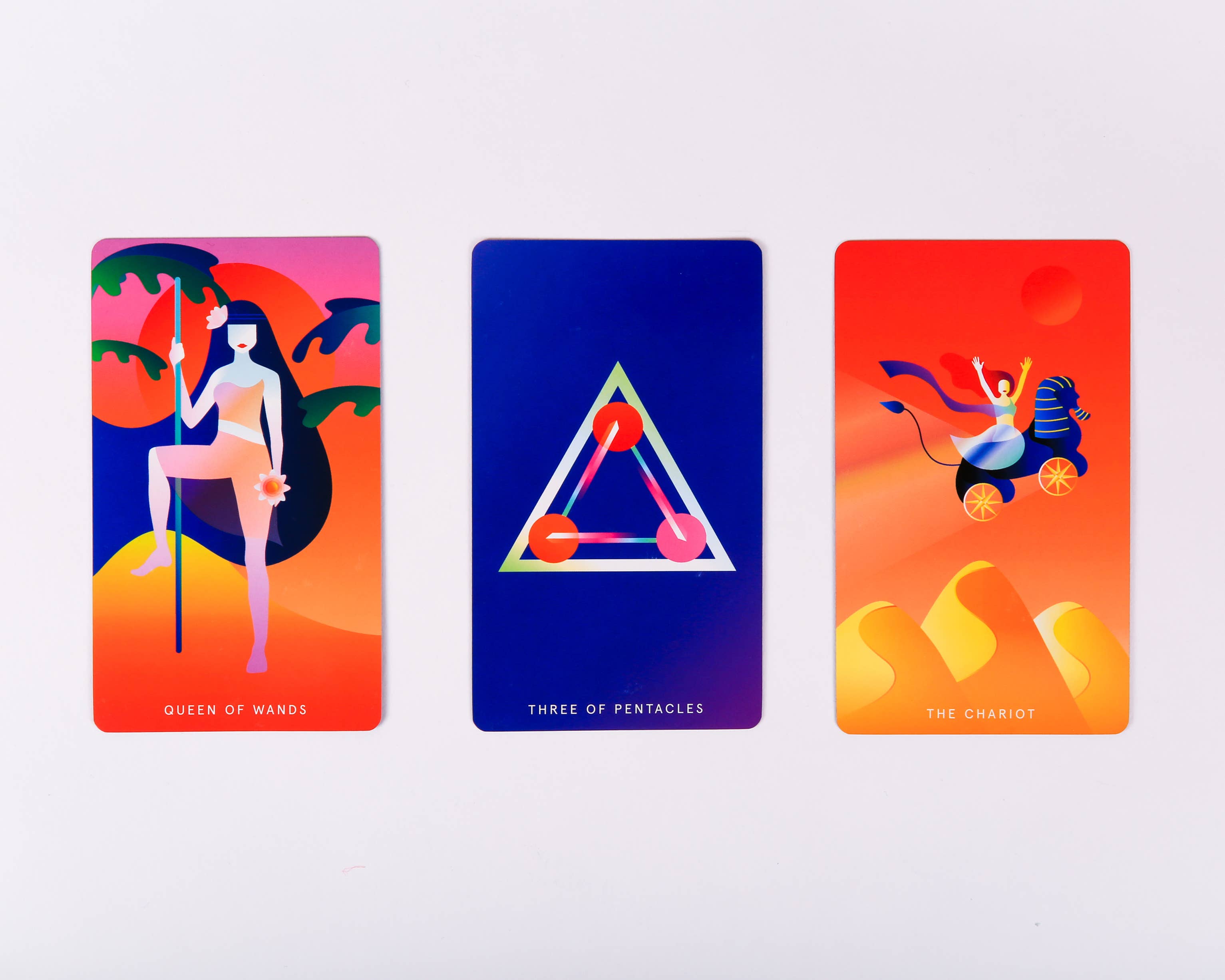 Three tarot cards with colorful designs and text on a white background
