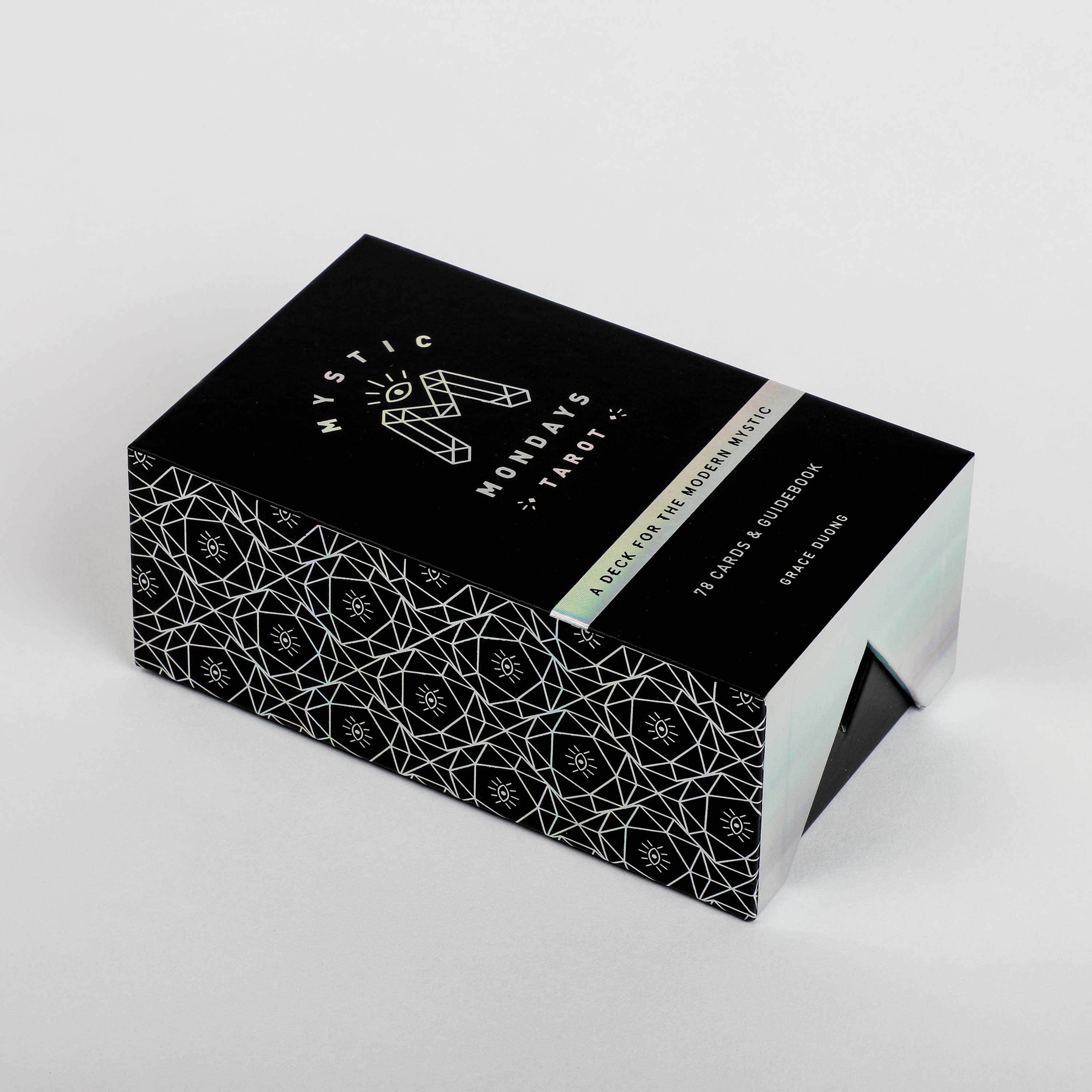 Black and white patterned box with 'Mystic Mondays' branding on a light gray background