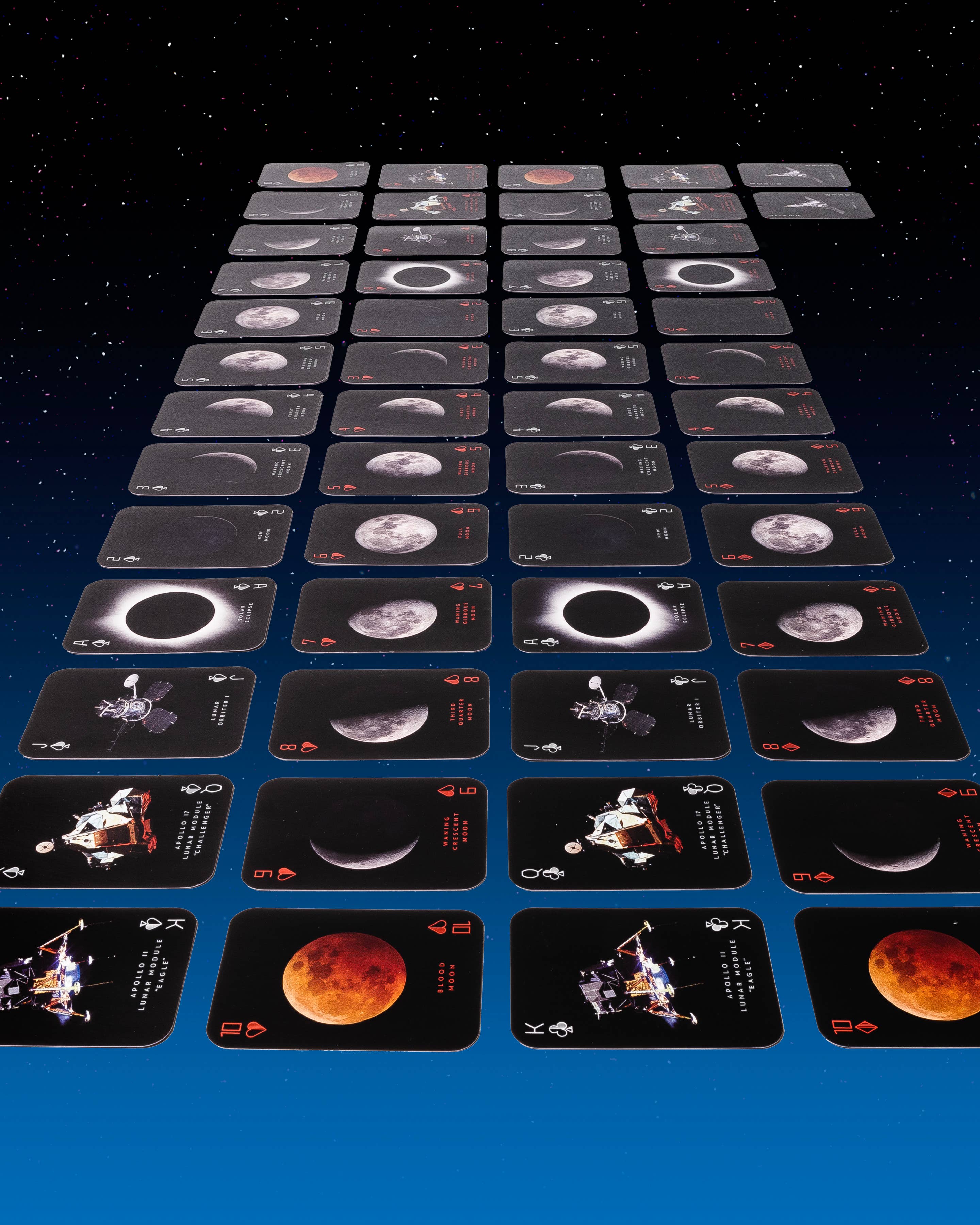 Collection of space-themed playing cards on a dark background