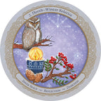 Decorative plate with an owl, candle, and holly design on a purple background.