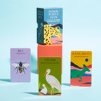 Card game packaging with animal illustrations on a light blue background