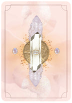 Decorative light switch plate with crystals and a coin on a pink background