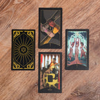Four tarot cards on a wooden surface