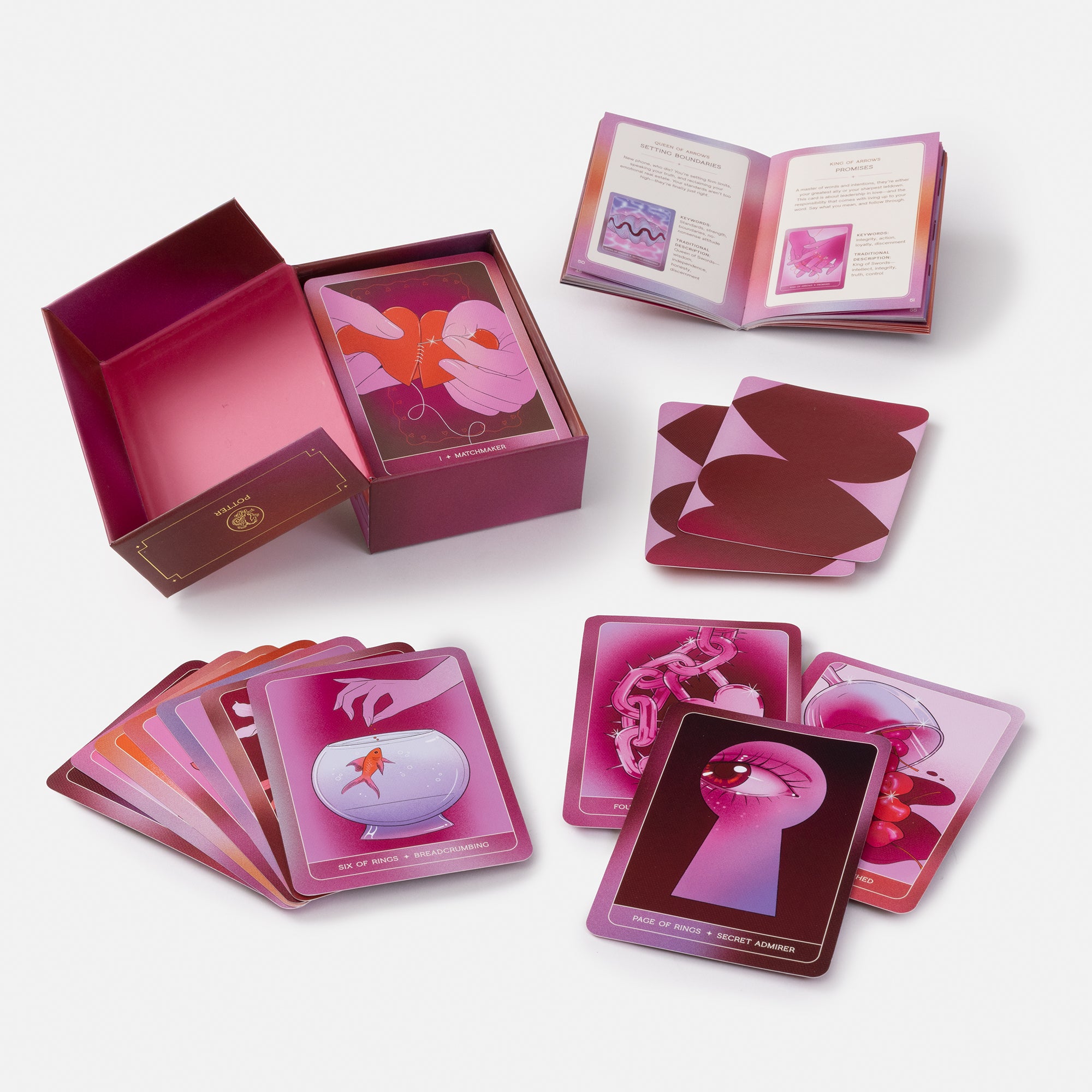 A pink and purple oracle card deck set displayed on a light gray background, including an open box, an open booklet, a stack of cards, and several individual cards showing illustrated designs.