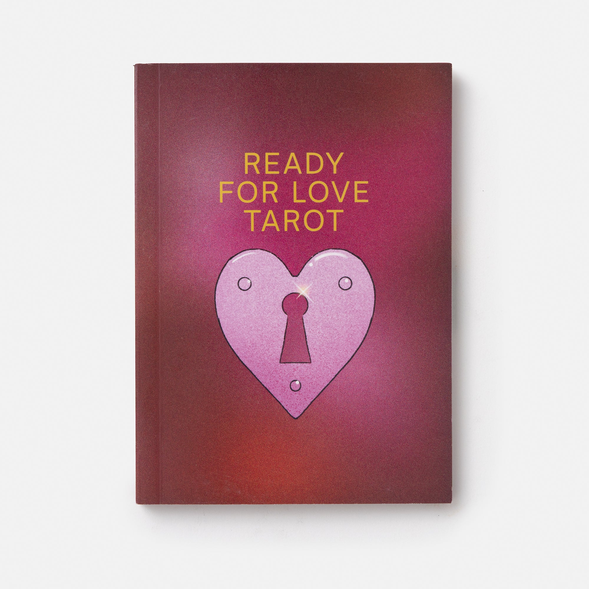 A tarot deck box titled 'READY FOR LOVE TAROT' featuring a pink heart-shaped padlock illustration on a red and purple gradient background, set against a clean white backdrop.