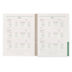Open gardening journal with plant care chart on a white background