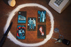 Tarot cards arranged in a circle on a wooden surface with a knife and keys.