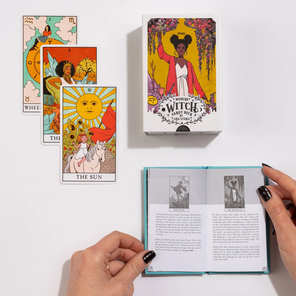 Witch tarot cards with a box and an open book on a white background