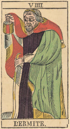 Card from a tarot deck featuring a figure labeled 'Lçermite' with colorful clothing.