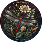 Decorative circular design with a dragonfly, flowers, and leaves on a dark background.