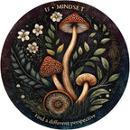 Circular artwork with mushrooms, flowers, and leaves, featuring the text 'MINDSET is a different perspective'.