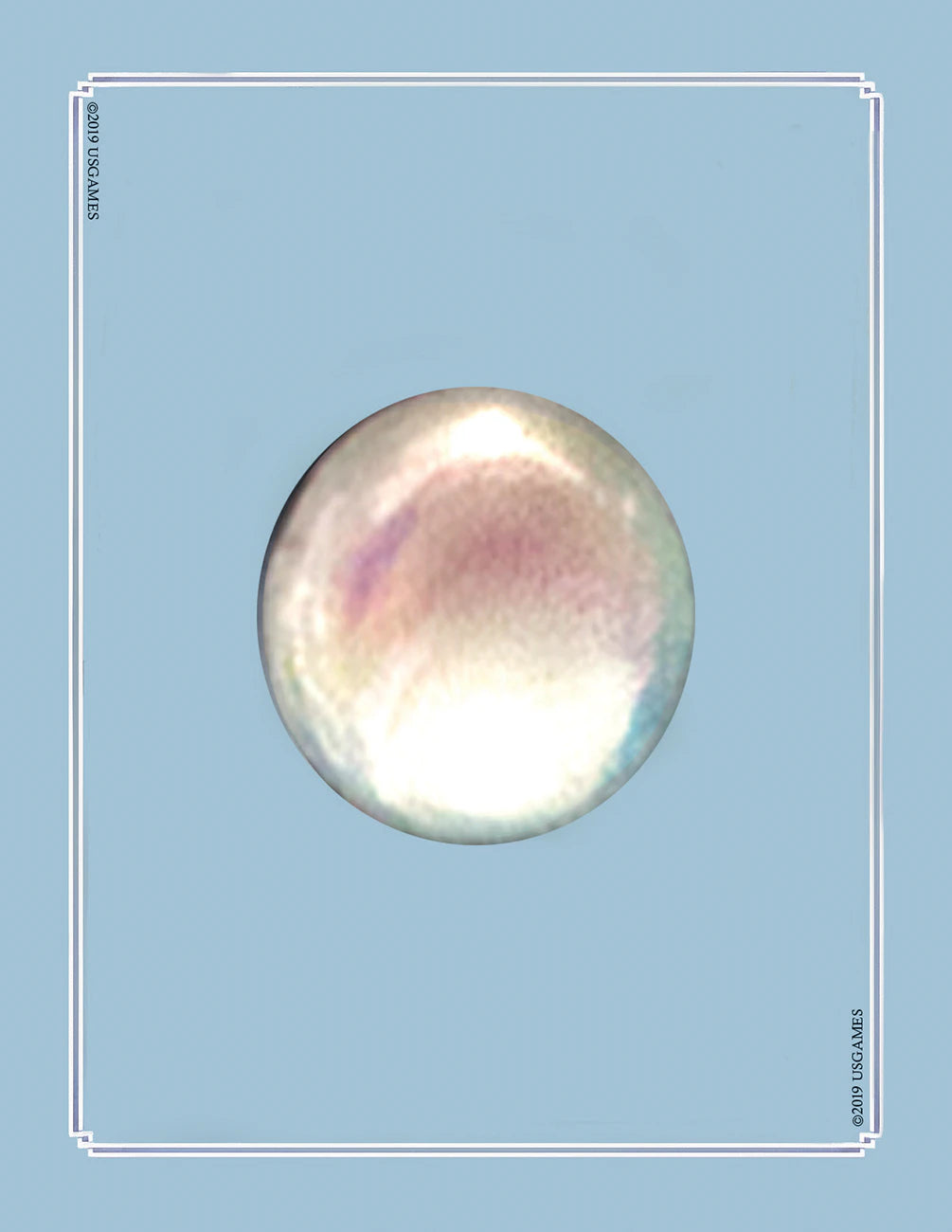 Round, iridescent object on a light blue background