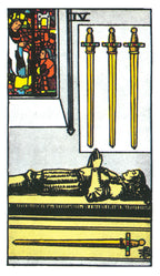 Tarot card with three gold swords, a figure lying on the ground, and a small inset of a person holding a candle.