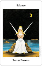 Tarot card titled 'Two of Swords' featuring a woman with two swords on a beach at night.