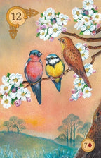 Three birds perched on a branch with flowers and a scenic background
