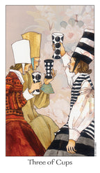 Card from a tarot deck titled 'Three of Cups' featuring three people holding cups.
