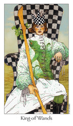 Card from a tarot deck featuring a person in a green outfit with a checkered hat, holding a staff, sitting on a checkered chair.