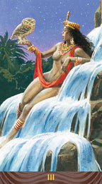 Woman sitting on a waterfall holding an owl, surrounded by nature