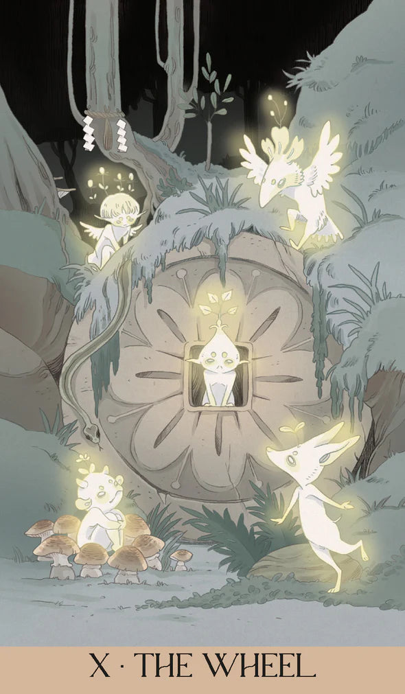 Card X - The Wheel from the Yokai Tarot. Little glowing creatures float near/around a "wheel" that is within the earth.