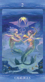 Tarot card featuring two mermaids with a glowing chalice in an underwater setting.