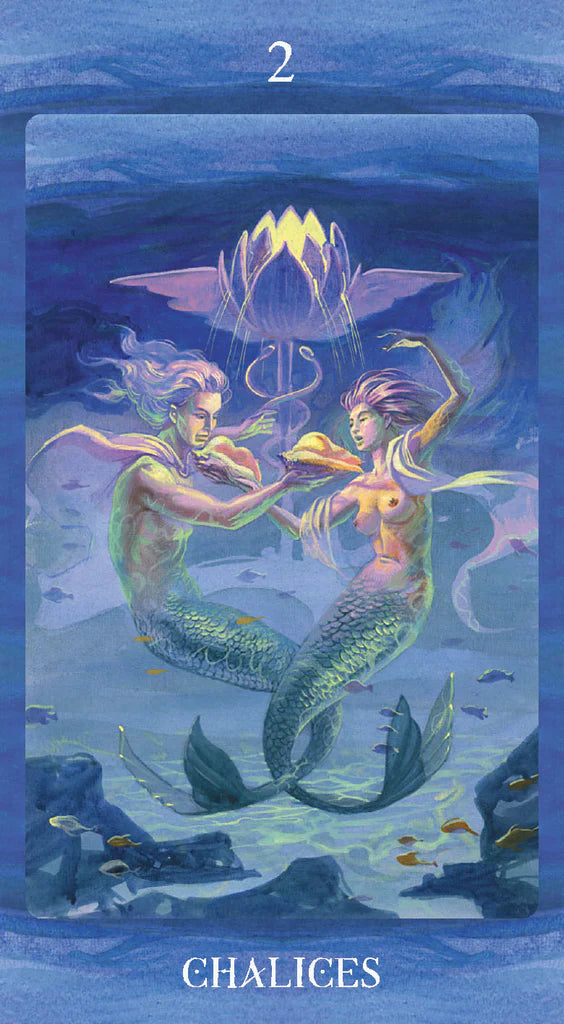 Tarot card featuring two mermaids with a glowing chalice in an underwater setting.