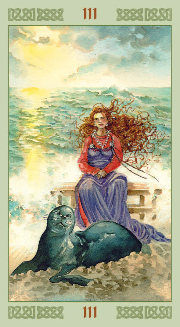 Tarot card with a woman and seal by the sea