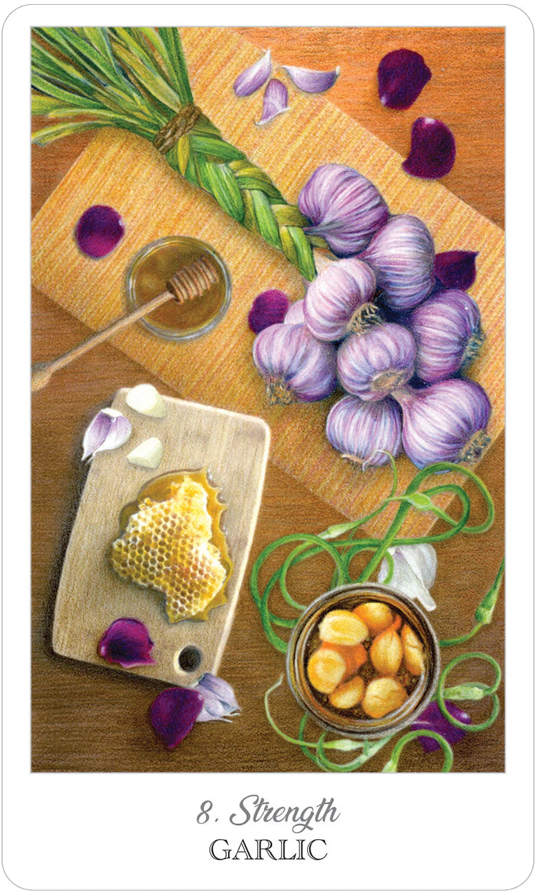 Garlic on a wooden board with honey and honeycomb, surrounded by flowers and leaves.