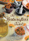 Book cover of 'The Herbcrafters Tarot' with herbs, bottles, and mortar and pestle on a textured background.