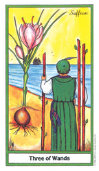 Tarot card titled 'Three of Wands' featuring a person in a green dress holding wands and a pink flower.