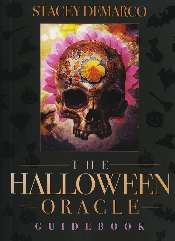 Book cover of 'The Halloween Oracle Guidebook' by Stacey DeMarco with a skull and floral design.