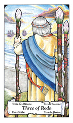 Card from a tarot deck featuring a figure holding three rods with a scenic background.
