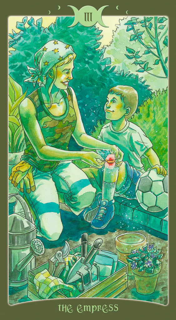 Tarot card featuring 'The Empress' with a woman and child in a garden setting.