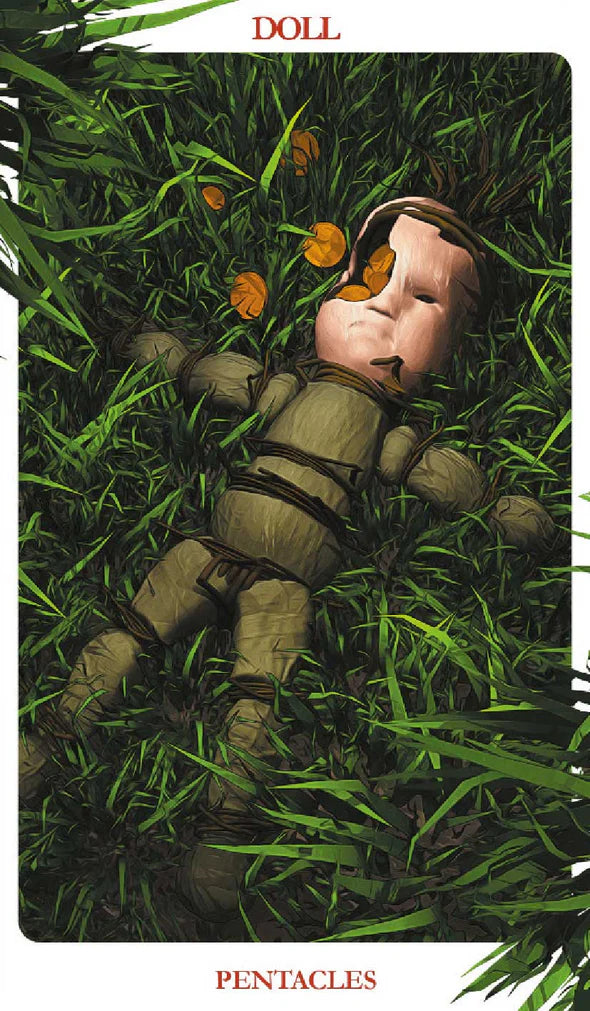 DOLL  | PENTACLES Card from a tarot deck featuring a doll lying on grass with pentacle symbols.