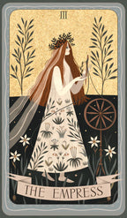 Tarot card featuring 'The Empress' with a woman holding a spinning wheel and surrounded by nature elements.