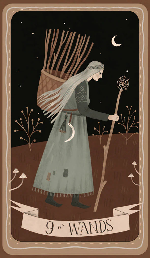Tarot card featuring a figure with a bundle of sticks and a staff against a night sky.