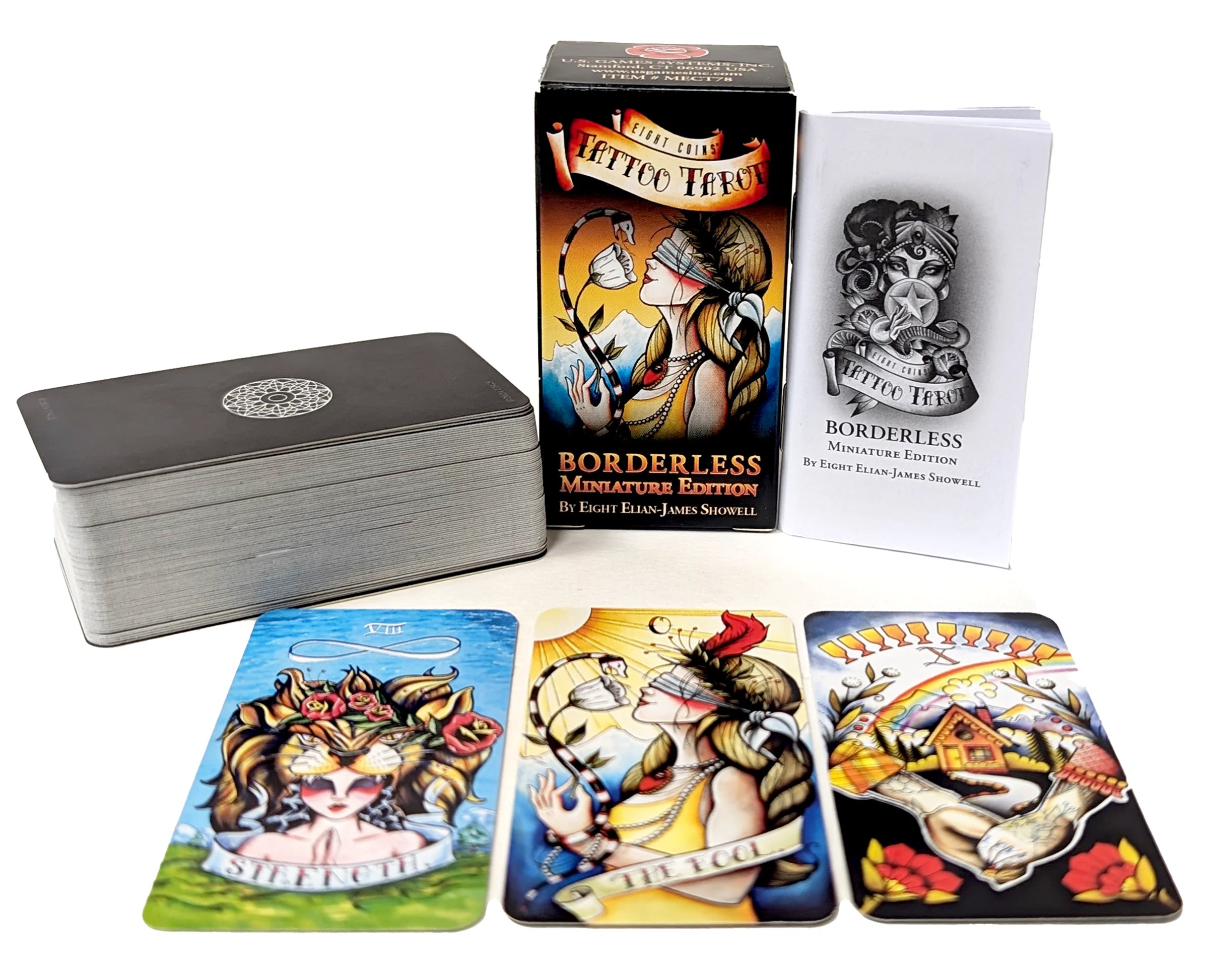 Collection of tattoo-themed playing cards with a box and card holder on a white background