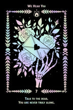 A tarot-style art print featuring a black background with a pastel iridescent border, a skeletal hand holding an open envelope, and roses. The text reads 'WE HEAR YOU' at the top and 'TALK TO THE DEAD.