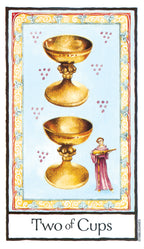 Two of Cups tarot card with two gold cups and a person holding a sword on a decorative border.
