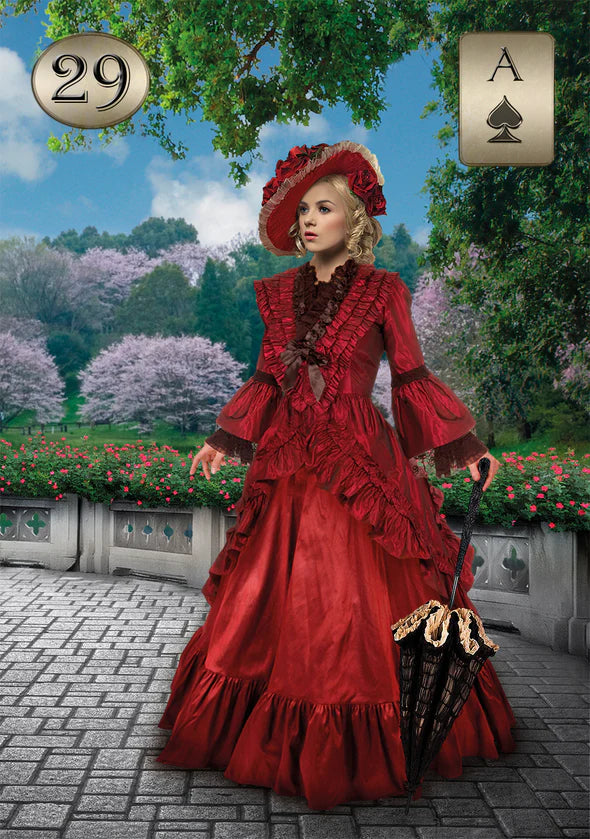 Woman in a red vintage dress standing in a garden with decorative elements.